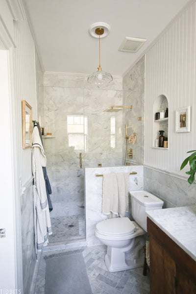 Tour our newly finished master bathroom reveal, featuring marble, gold, vintage wood and other beautiful organic raw textures.